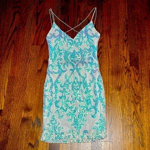 White with silver sparkles. Short dress with spaghetti strap back